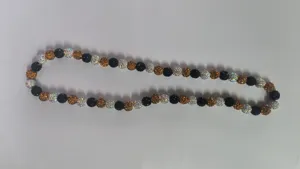 Detailed view of 10mm Shamballa disco ball necklace with black, amber, and white rhinestones