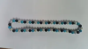 Detail view of a 10mm turquoise and black Shamballa disco ball bead hip hop necklace