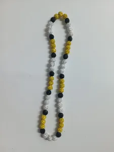 Detail shot of 10mm Shamballa rhinestone clay beads on a yellow and black elastic necklace.