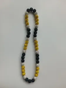 Detail shot of a sparkling Shamballa necklace with black, yellow and white disco beads.