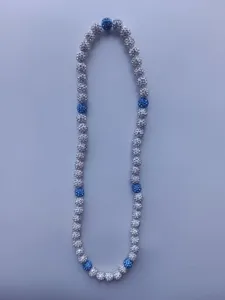 Macro detail of a Shamballa necklace featuring sparkly white and blue rhinestone beads