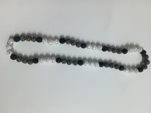 Close-up detail of a 10mm Shamballa disco ball necklace with black and silver pave beads.