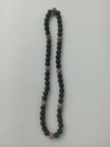 Close-up showing the detail of 10mm black textured and pink rhinestone shamballa beads