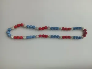 Close-up of patriotic red white and blue rhinestone beads on a shamballa necklace.