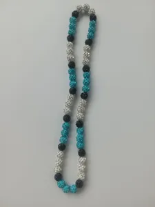 Macro detail view of 10mm Shamballa necklace with teal and black rhinestone beads