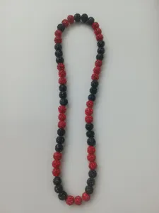 Detailed view of 10mm red and black rhinestone clay beads in a hip hop style necklace.