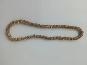 Close-up shot of 10mm sparkling golden rhinestone Shamballa beads on a clay jewelry necklace