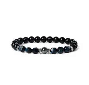 Detailed view of natural gemstone beaded bracelet with blue tiger eye and black beads.