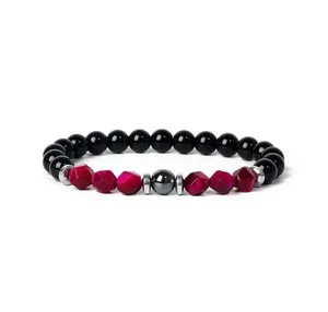 Detail shot of natural stone beaded bracelet featuring faceted pink stones and black onyx beads.