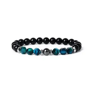 Close-up detail of blue faceted tiger eye and black gemstone beaded bracelet, yoga jewelry.