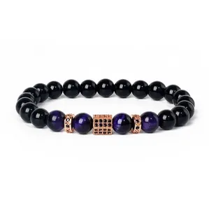 Detailed view of the 8mm tiger eye and black stone beaded bracelet with zirconia charms.
