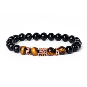 Close-up of beaded bracelet detail featuring tiger eye and black stones with micro zircon.