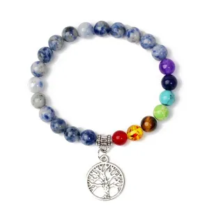 Detailed shot of the chakra stone beaded bracelet featuring a silver tree of life charm.