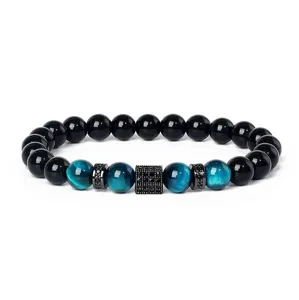 Close-up detail of beaded bracelet featuring blue tiger eye, black beads and sparkling spacers.