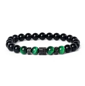 Detailed view of 8mm green tiger eye and black stone bracelet with micro-paved cubic zirconia.