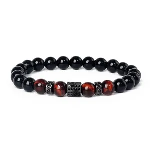 Close-up detail of beaded bracelet featuring tiger eye, obsidian and paved zirconia spacers.