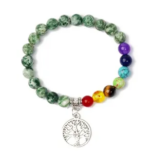 Detailed close-up view showing the crystal gemstone beads and silver tree of life charm detail.
