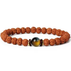Close-up detail shot of the rudraksha beaded bracelet with central gemstone and wooden spacers.