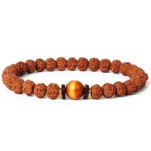 Close-up detail of the 7mm rudraksha beaded bracelet with a smooth central gemstone bead.