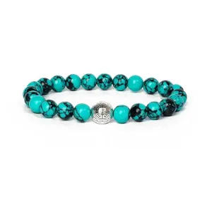 Turquoise stone beaded bracelet with ornate silver spacer bead, ideal yoga jewelry piece.