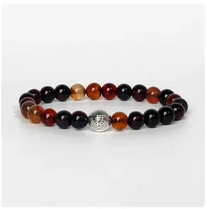 Detail shot of multi-color agate beaded yoga bracelet with central metal spacer bead.