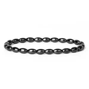 Close-up detail of black hematite oval beaded bracelet with metallic sheen texture.