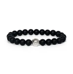 Matte black stone beaded bracelet with silver alloy center charm detail close up view