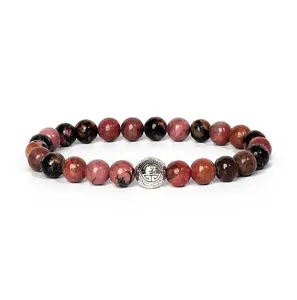 Detailed close-up view of natural gemstone beaded bracelet with stylish silver charm.