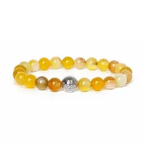 Natural gemstone beaded bracelet detail shot, elegant yellow agate with metal spacer.
