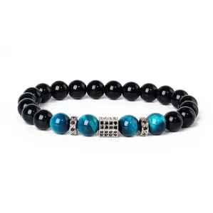 Blue tiger eye and black stone beaded bracelet detail with paved zircon metal spacer charm.