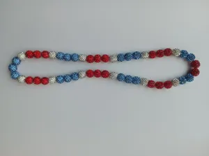 Detailed view of red, white, and blue rhinestone disco ball beads on a Shamballa necklace.
