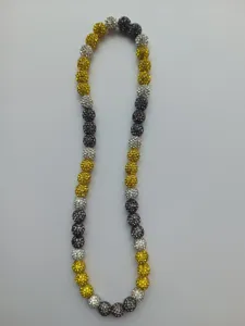 Detailed view of 10mm Shamballa clay beads with yellow, silver, and black rhinestones