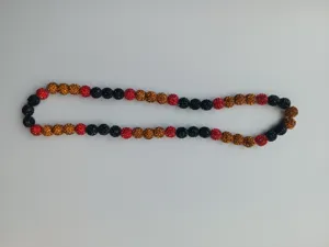 Close-up detail of 10mm Shamballa rhinestone beads in red, black, and amber colors.