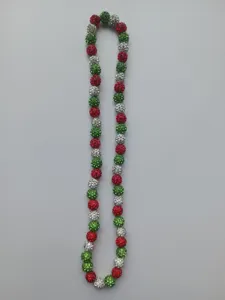 Close-up of 10mm red green and silver rhinestone Shamballa beads on a strand