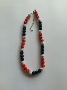 Detailed view of red, black and silver crystal rhinestone ball beaded fashion necklace.