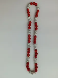 Macro view of 10mm red and white crystal Shamballa beads on an elastic necklace string.
