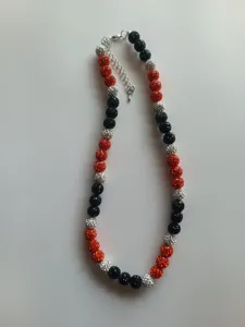 Detailed view of a 10mm rhinestone clay bead shamballa necklace in red, black, and silver.