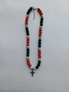 Detail view of the red black silver rhinestone shamballa bead necklace with a cross.