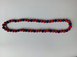 Close-up detail of 10mm red and blue rhinestone clay bead Shamballa necklace beads.