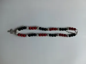 Detailed view of the sparkling rhinestone Shamballa bead cross necklace in red black silver.