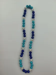 Macro detail of a sparkling Shamballa bead necklace in assorted blue and silver tones.