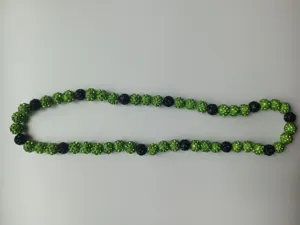 Shamballa necklace featuring green and black clay disco ball beads with crystals.
