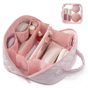 Detail view of large capacity pink quilted cosmetic bag with multi-compartment interior