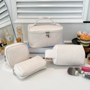 Detailed view of cream quilted PU leather cosmetic bags with elegant storage design