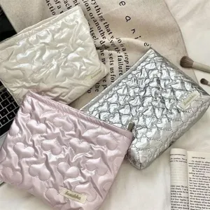 Variety of soft quilted heart-pattern PU makeup pouches in pink, silver, and white colors