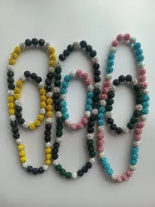 Detailed view of colorful 10mm Shamballa bead necklaces and bracelets with rhinestones.