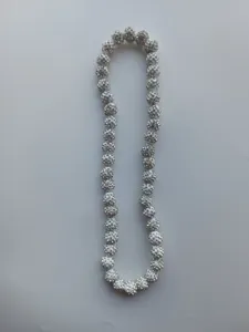 Detailed macro shot of a Shamballa necklace featuring white clay disco ball beads with silver stones