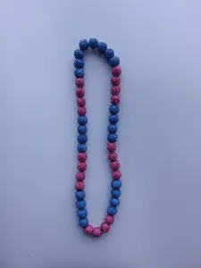Close-up view of a vibrant blue and pink rhinestone Shamballa bead necklace set.