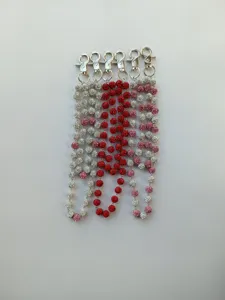 Detailed view of sparkling rhinestone disco ball chains with metal lobster clasps, assorted colors.