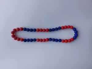 Detailed macro view of red and blue rhinestone clay beads on a sparkling Shamballa necklace